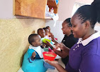 Staff feeding a toddler