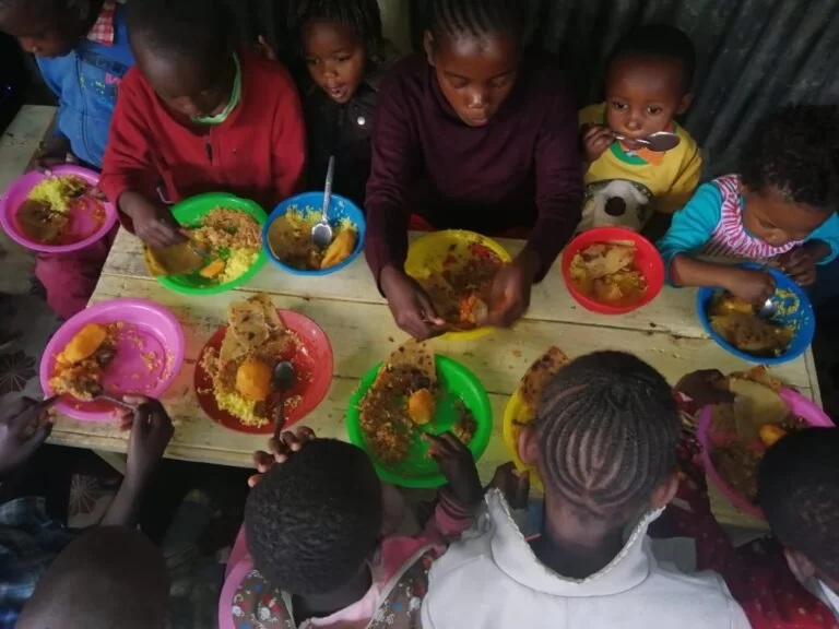 Children eating from colourful plates