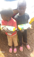 Two boys holding juice packs